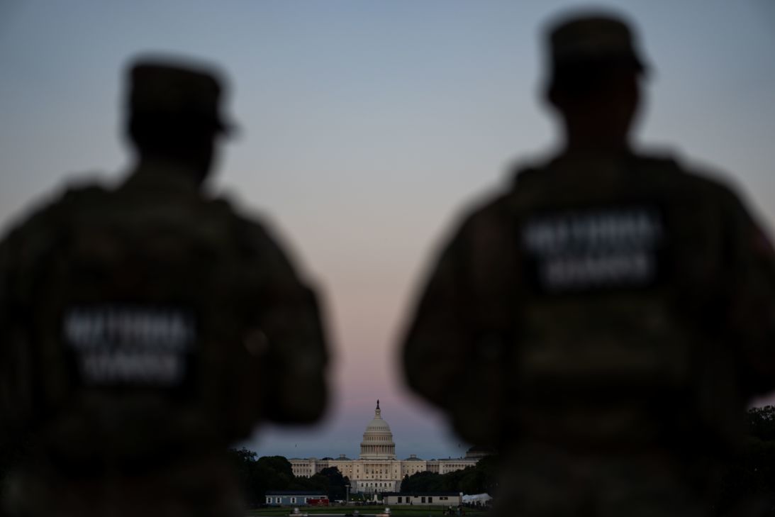 Members of the National Guard are seen cast in silhouette while standing at the Washington Monument, on September 2, in Washington, DC.