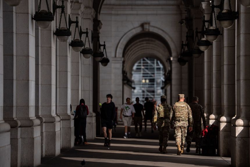 Members of the National Guard and members of Federal Law Enforcement Agencies stand outside the main hall of Union Station, on September 4, in Washington, DC.