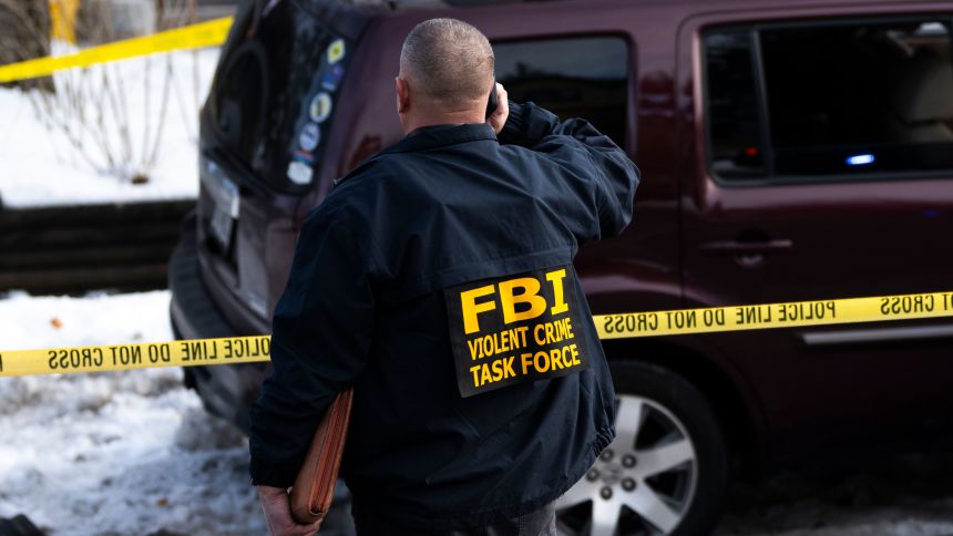 An FBI agent at the scene of the shooting in Minneapolis.
